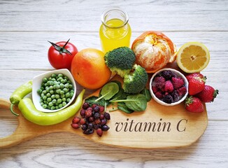 Food high in vitamin C for strong immune system. Assortment of natural products rich in vitamin C. Fresh fruit and vegetable; best food sources of vitamin c tomato, juice, strawberry, pepper, spinach