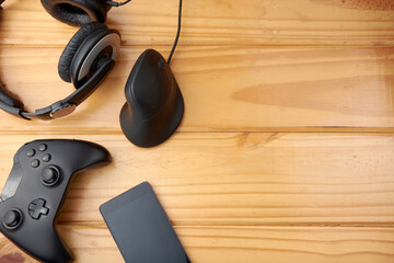 A top view of ergonomic gaming accessories with game controller, vertical mouse, headphones and...
