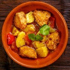Food for suhoor in ramadan lamb stew with potatoes on a wooden board.