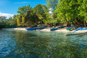 Boats on the beach of the small island of Poyalisa which is part of the Togian archipelago on Sulawesi. The Togian Islands in the Gulf of Tomini are a paradise for divers and snorkelers