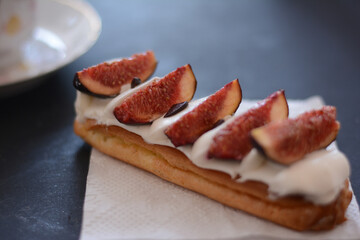 French eclair with white cream and fig wedges