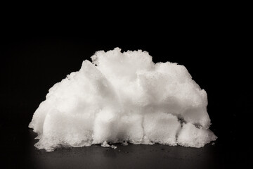 Heap of white snow on black background.The structure of snow and ice. Close-up.