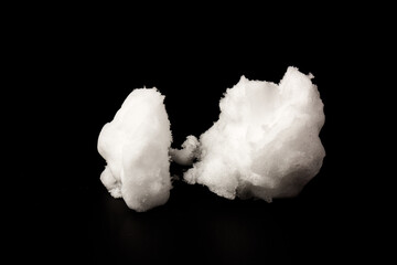 Heap of white snow on black background.The structure of snow and ice. Close-up.
