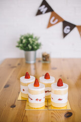Strawberry shortcakes with whipped cream and fresh berries on wooden table