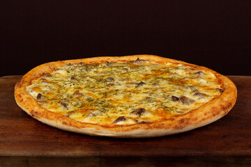 One pizza of meat or rump or filet, on wooden table