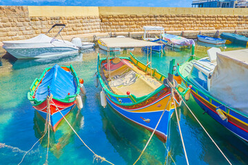 Fototapeta na wymiar The traditional luzzu boats in Bugibba, Malta