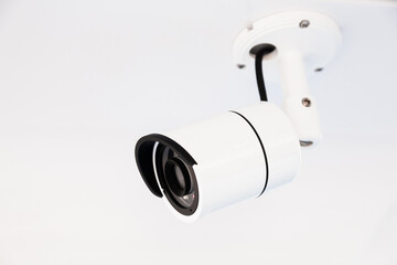 CCTV camera on the hull of an expensive motor yacht. CCTV camera white on a white body.