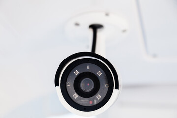 CCTV camera on the hull of an expensive motor yacht. CCTV camera white on a white body.
