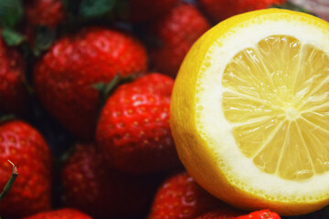 Naklejka na ściany i meble Fresh delicious fruits on white marble table: red strawberries, yellow lemons, green limes