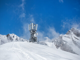 Antenna and Transceiver 5G, 4G on top of the mountains in winter with snow. Copy space