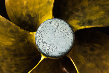 Five-bladed ship propeller close-up, with zinc corrosion protection in the center.