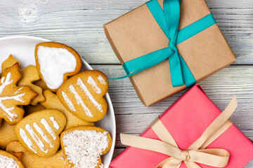 Christmas cookies on a plate and several gift boxes. Christmas presents.