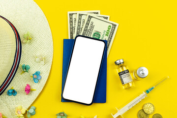 Summer vacation during coronavirus covid-19 background with screen mockup, mobile phone with blank white screen and vaccine vials on a yellow background, summer holiday and trip 2021 concept photo