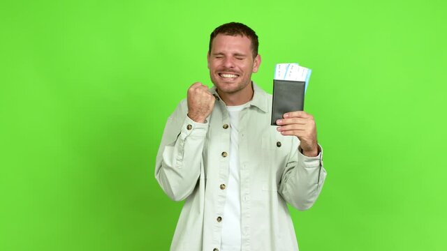 Brazilian handsome man holding a passport and doing surprise gesture over isolated background