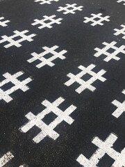 Has tag symbol on asphalt.A hashtag is a metadata tag that is prefaced by the hash symbol, #....