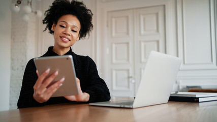 A woman keeps online accounting of expenses for a month at home. Records costs in a convenient app....