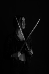 Black and white portrait of a woman with vintage bayonet knife in her hands