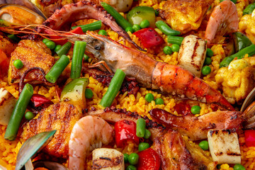 Paella. Spanish dish of rice and seafood, vegetables and chicken. Shrimp, octopus, crab and mussels. Banquet festive dishes. Gourmet restaurant menu. White background. Pattern