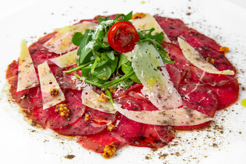 Dry aged beef carpaccio dry aged beef carpaccio. Banquet festive dishes. Gourmet restaurant menu. White background.