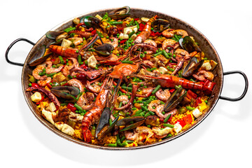 Paella. Huge frying pan. Spanish dish of rice and seafood, vegetables and chicken. Shrimp, octopus, crab and mussels. Banquet festive dishes. Gourmet restaurant menu. White background.