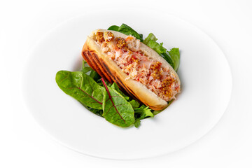 Hot dog with crab meat, mustard and herbs. Banquet festive dishes. Gourmet restaurant menu. White background.