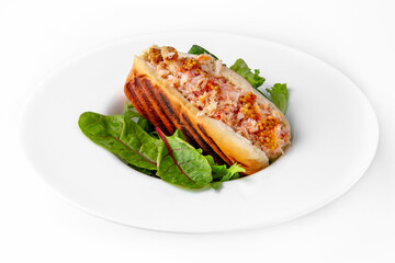Hot dog with crab meat, mustard and herbs. Banquet festive dishes. Gourmet restaurant menu. White background.