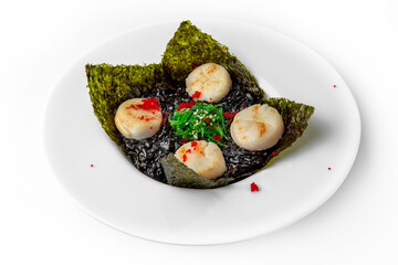 Delicate fragrant scallops in black risotto with cuttlefish ink. Seafood dish. Seafood dish. Gourmet restaurant menu. White background. 