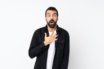 Young man with beard over isolated white background surprised and shocked while looking right