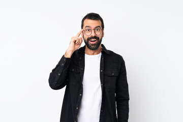 Young man with beard over isolated white background with glasses and surprised