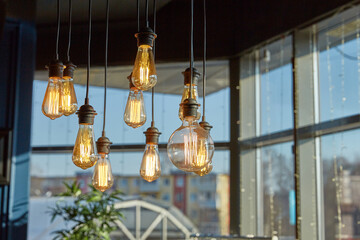 Decorative ceiling light bulbs shine with a dim light. Home decoration and interior elements