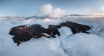 Aerial Panorama of active lava river flows from a volcanic eruption in mount Fagradalsfjall...