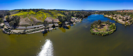 a breathtaking aerial panoramic shot of the vast green lake water and majestic mountain ranges...
