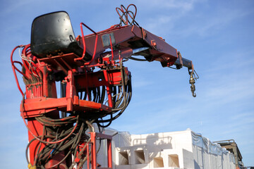 Unloading building blocks from a truck using a crane. Hydraulic manipulator.