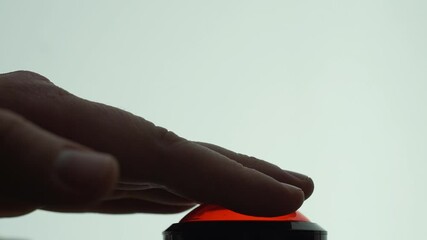 Finger presses the big red button 