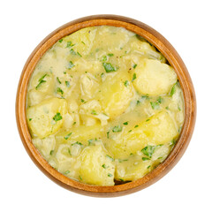 Potato salad with oil and vinegar in a wooden bowl. Traditional southern German and Austrian side dish made from boiled potatoes, oil, vinegar, onion and parsley. Close up over white macro food photo.