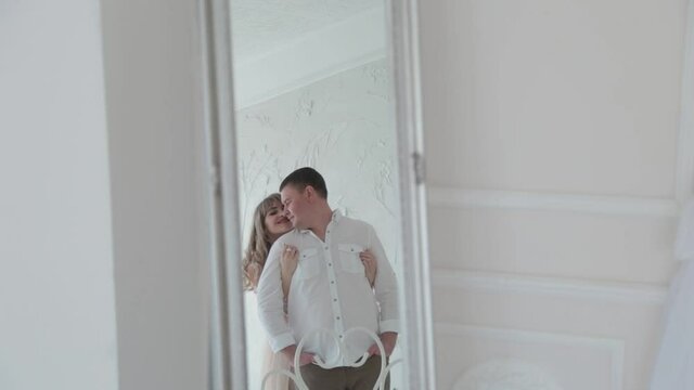 Lovers bask in the light room of the photo studio.