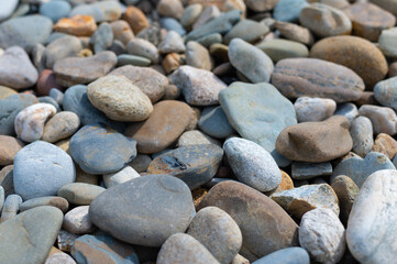 background of gray and red stones on the beach in the afternoon in the sun in summer. High quality photo