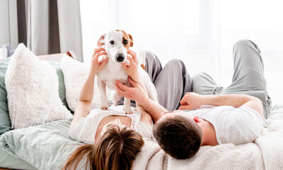 Couple in the bed with dog