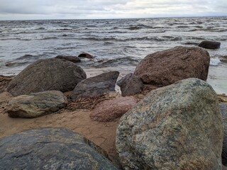 large stones on the shore against the background of the sea