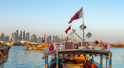 Traditional Arabic Dhow boats along with Doha skyline.