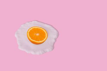 Minimal idea made from fried egg and orange fruit. Creative and humorous presentation of food.