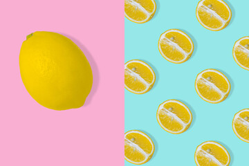 Trendy summer idea Pattern with yellow lemon slice on pastel blue background and whole fresh lemon on light pink background.