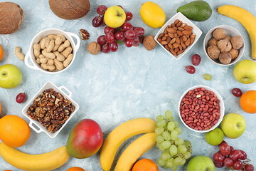 Fresh summer tropical fruits and nuts assortment on a bright sunny table, citrus mix, detox diet and weight loss concepts, banner, advertising for a store, healthy and natural food, selective focus