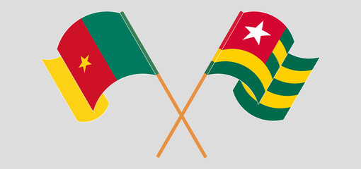 Crossed and waving flags of Cameroon and Togo