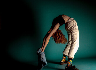 Contemporary style dancer on dark wall