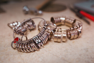 Workshop with goldsmith's tools and finger sizing gauges which are used to determine finger size.
