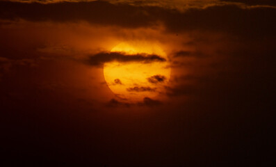 Clouds block the sun and golden skies.