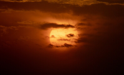 Clouds block the sun and golden skies.
