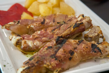 Roasted pork legs with fries on plate Spain