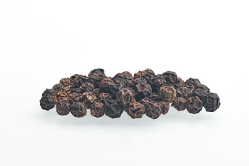 Black pepper grains isolated on white bacground. Heap of dry peppercorn spice. Black pepper seeds close up view.